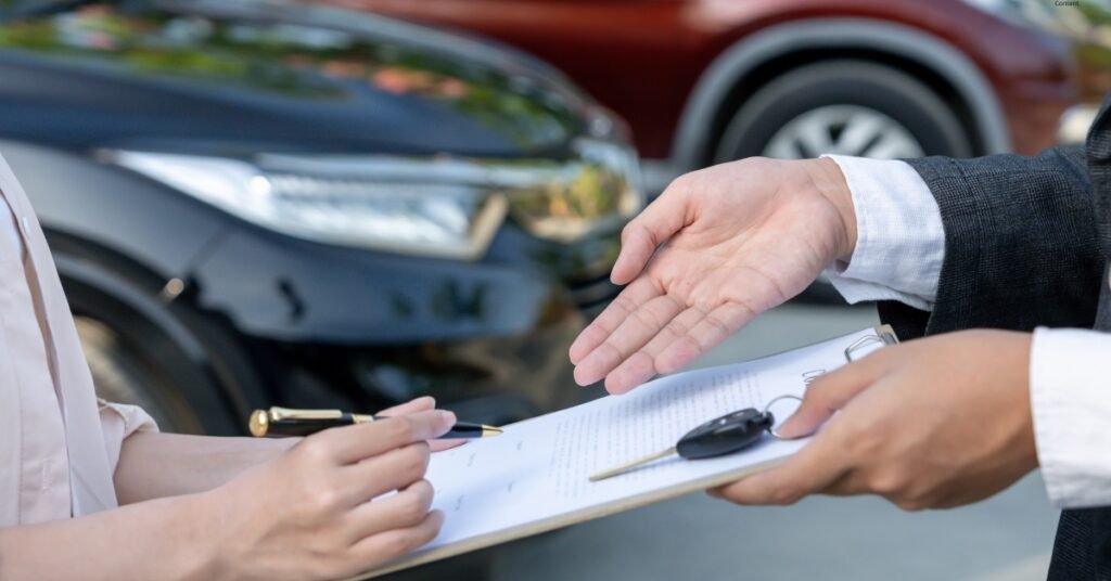 Manager is completing documentation with new car buyer